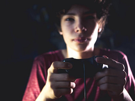 Young teen addicted to video games.