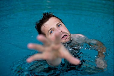 Drowning man desperately reaching for help.