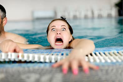 Woman drowning in swimming pool.